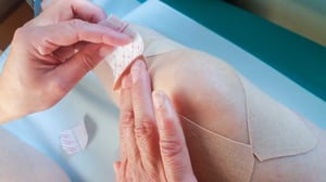 applying_adhesive_bandage_to_knee