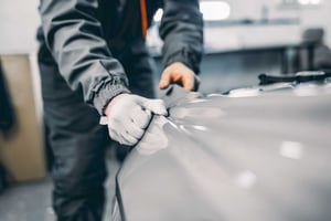 applying_paint_film_to_car_fender