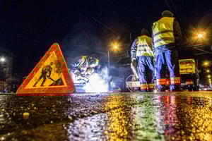 road_construction_crew_with_safety_sign