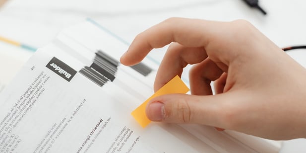 adhesive bonding attaches sticky note to book
