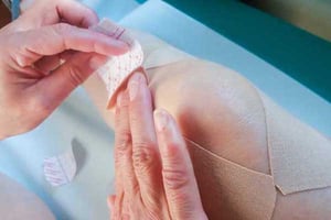applying_adhesive_bandage_to_knee-1